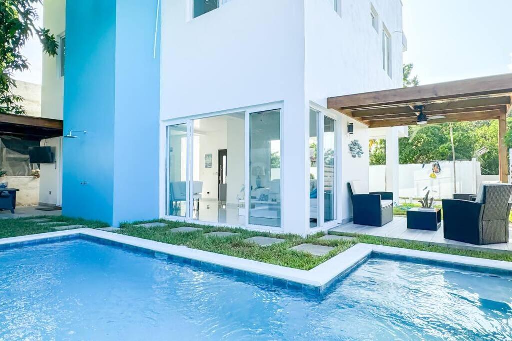 a swimming pool in front of a house at Atlantis Villages Poseidon in Tela