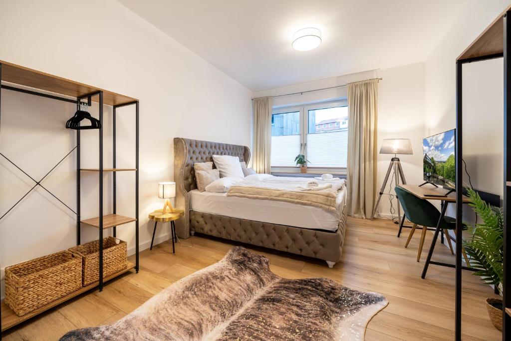 a bedroom with a bed and a window at Dein Citynest - FeWo Meier in Bielefeld