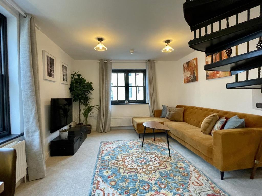 a living room with a couch and a tv at Cosy Oasis in the Heart of Clifton Village in Bristol