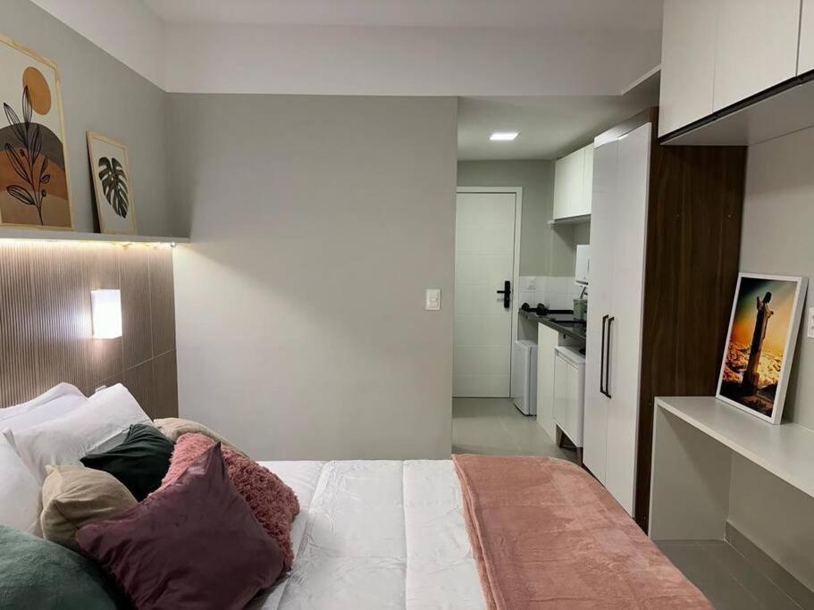 a bedroom with a bed and a kitchen at Studio 1111 in Rio de Janeiro
