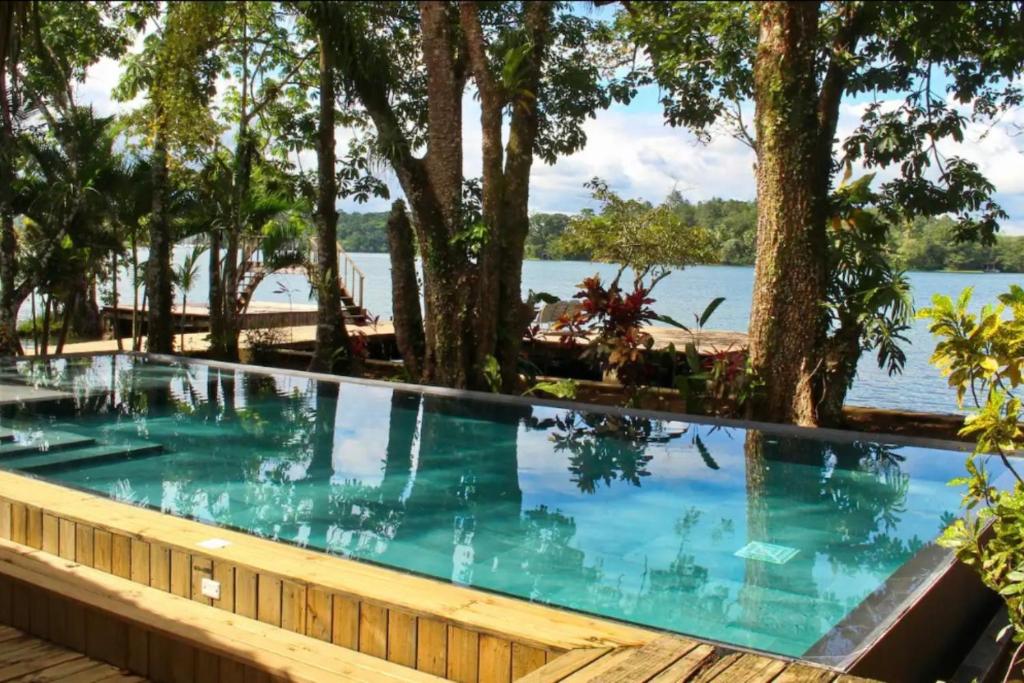 a swimming pool with a view of the water at Luxurious entire country house in Rio Dulce, Guatemala in Rio Dulce