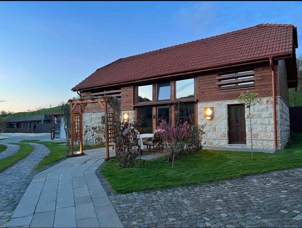 a brick house with a pathway leading to it at La Sura Germain 