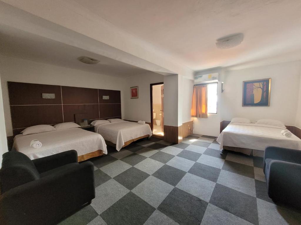 Postel nebo postele na pokoji v ubytování Hotel Costa Inn