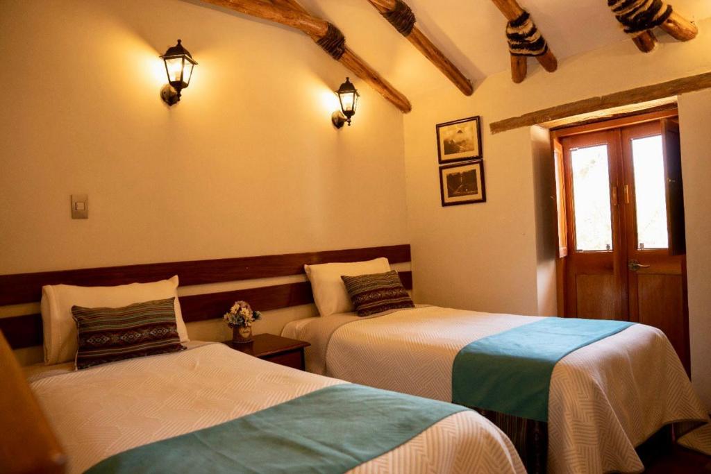 Postel nebo postele na pokoji v ubytování Lodge El Portal de Qopuy