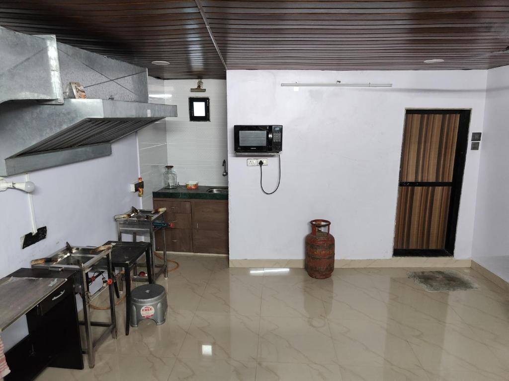 a kitchen with a stove and a sink in a room at HOUSE 101 in Mumbai