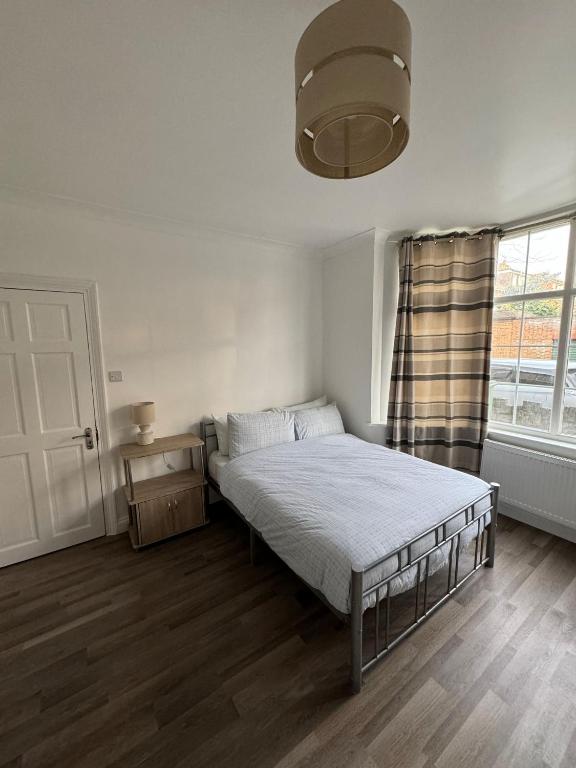 a white bedroom with a bed and a window at Oxborne Rooms UK - Gardner in London