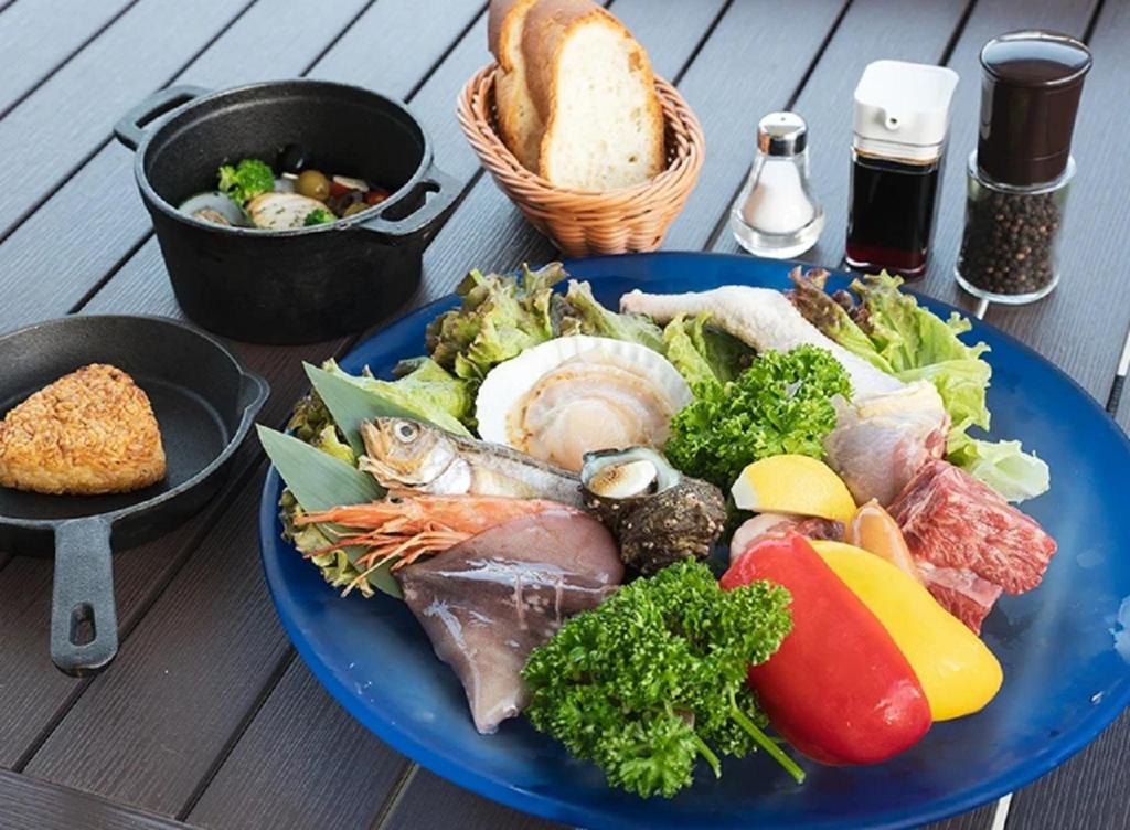 a blue plate of food on a wooden table at 99glam - Vacation STAY 42273v in Hirasawa