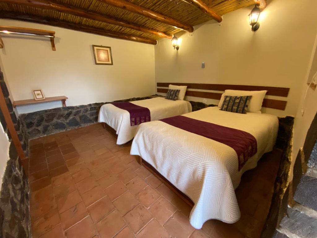 Postel nebo postele na pokoji v ubytování Lodge El Portal de Qopuy