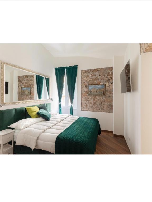 a bedroom with a bed and a mirror at Bretone XI b&b in Rome