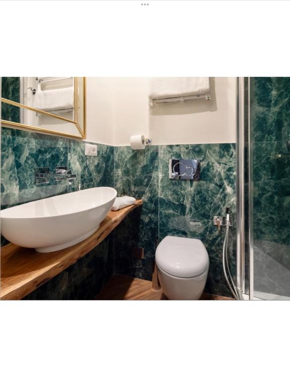 a bathroom with a sink and a toilet at Bretone XI b&b in Rome
