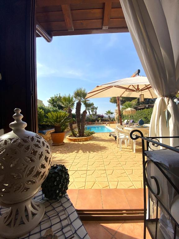 a vase sitting on a table next to a patio at Villa Verabetta in San Vito lo Capo
