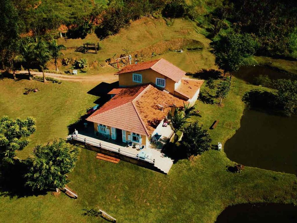 an aerial view of a house on a lake at Hotel Fazenda Monteiro in Conservatória