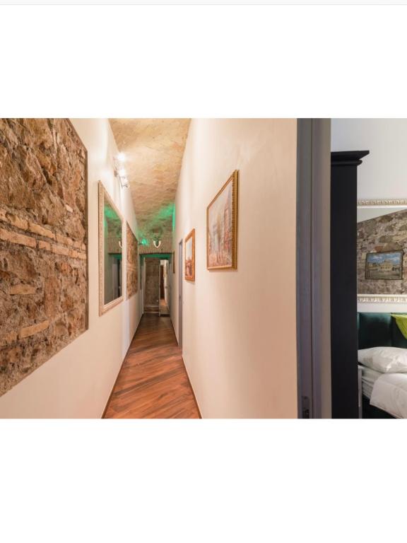 a hallway in a house with paintings on the walls at Bretone XI b&b in Rome