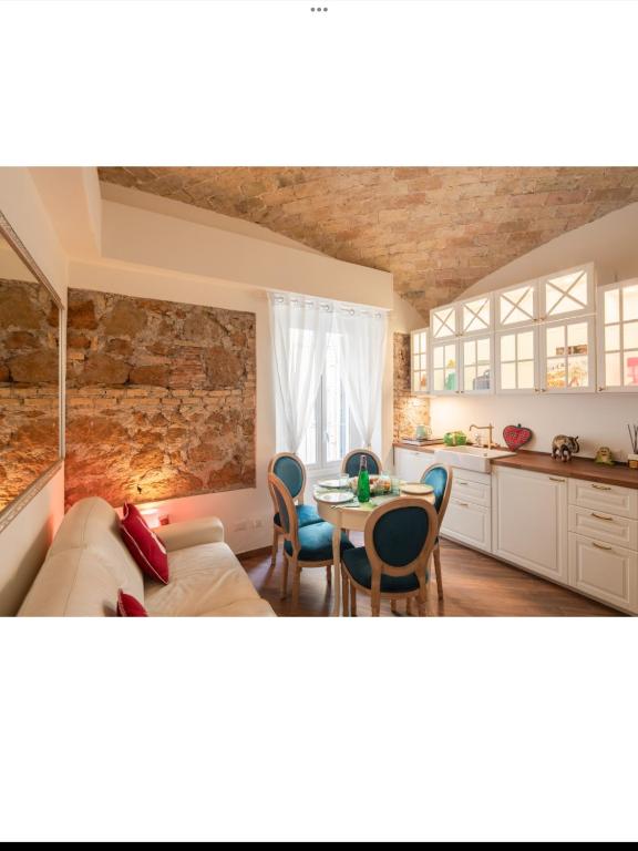 a kitchen and living room with a couch and a table at Bretone XI b&b in Rome