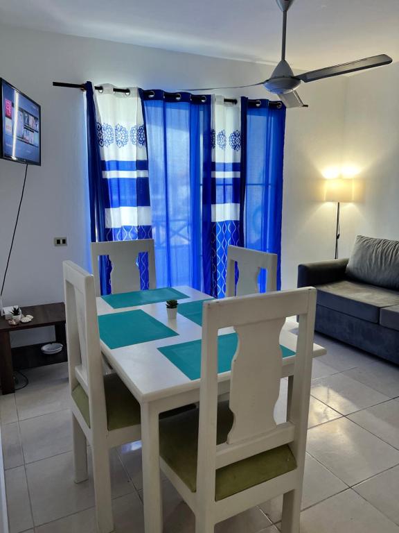 a dining room table and chairs in a living room at Playa Azul House in Bayahibe