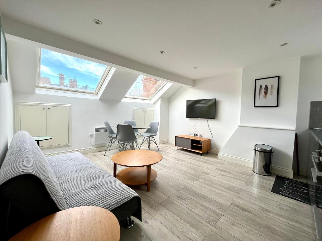 a living room with a couch and a tv at Central Morden, Westfield, close to Tube station in London