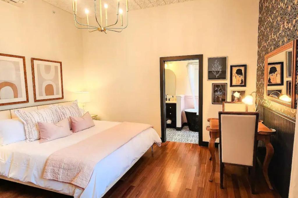 a bedroom with a bed and a table and a mirror at Speakeasy King Suite (Rm 8) in Nevada City