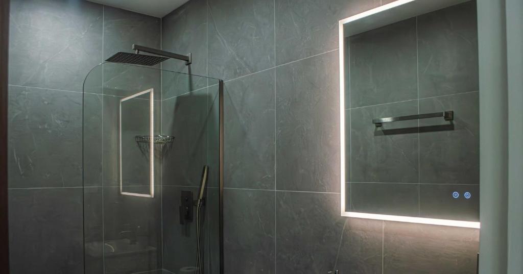 a bathroom with a shower with a glass door at The Palms Resort in Saint James