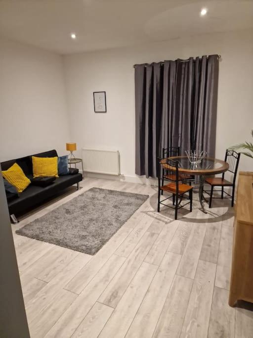 a living room with a couch and a table at Maidstone Modern Flat High Street in Kent