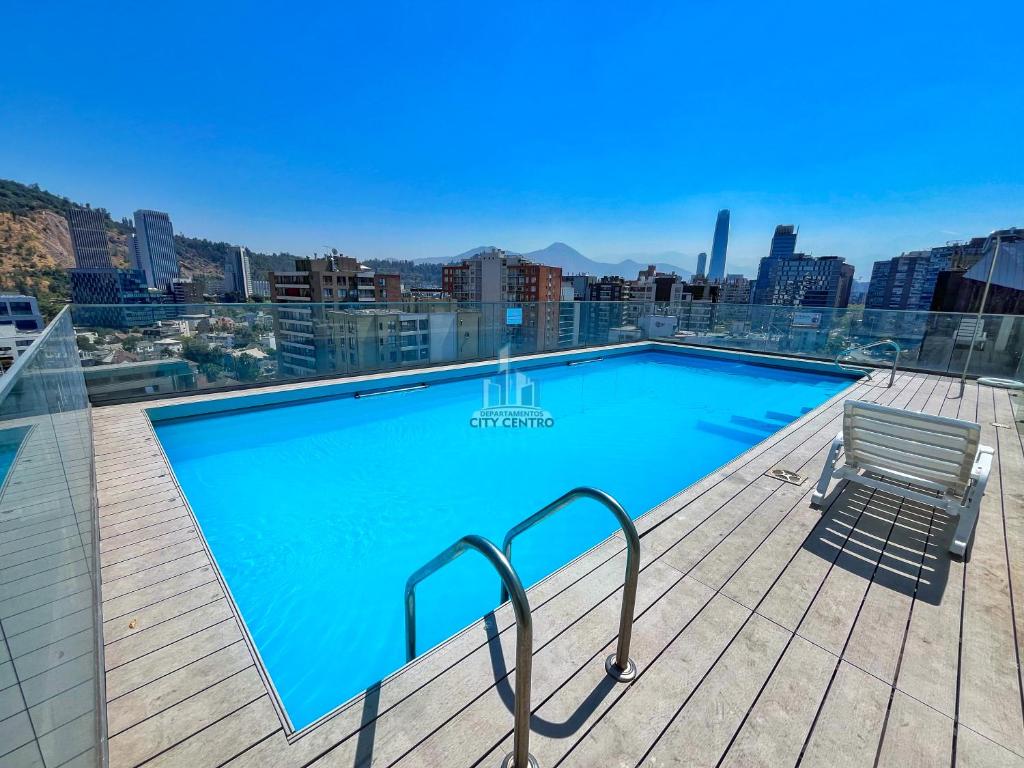 a swimming pool on the roof of a building at Apartamentos City Centro Manuel Montt in Santiago