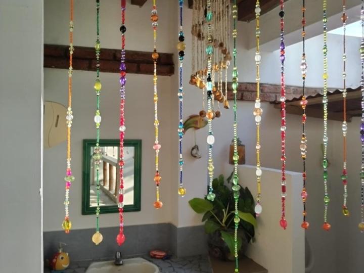 a bunch of beads hanging from a wall at Hospedaje Algarrobo Machalilla in Machalilla