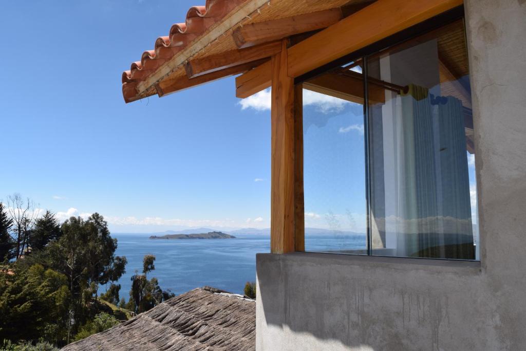 a window of a house with a view of the ocean at Casa de la Luna - ISLA DEL SOL in Comunidad Yumani