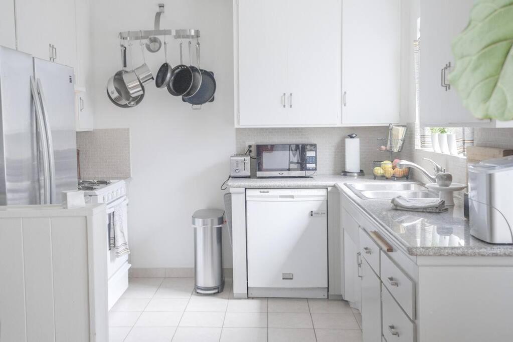 a kitchen with white cabinets and a white appliances at Hollywood Hills: laundry+parking+patio+kitchen+AC in Los Angeles