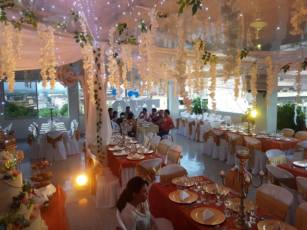 ネイバにあるHotel Sulicamの白いテーブルと白い椅子が備わる宴会場