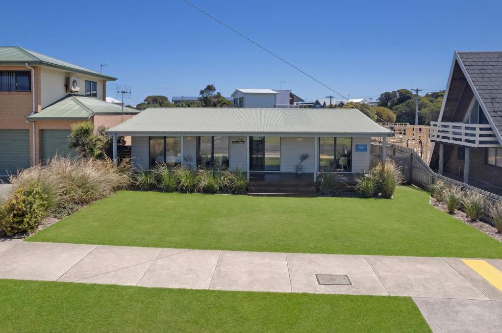 a house with a large lawn in front of it at Ocean Spray Retreat in Port Fairy
