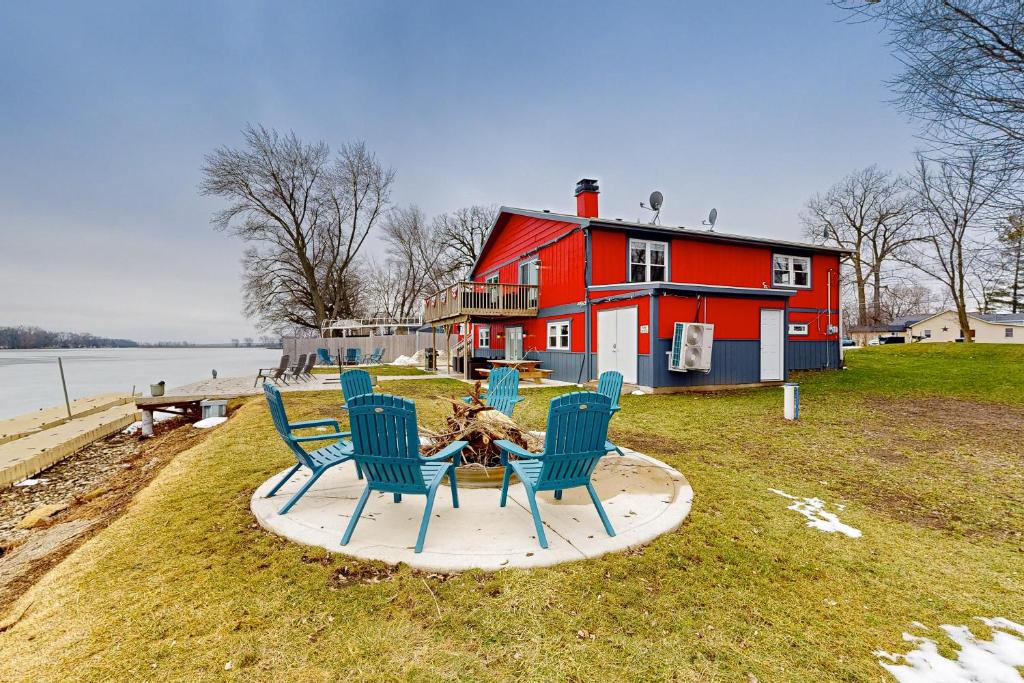 a group of chairs sitting in front of a red house at Casa de Nello - Upper Level in Antioch