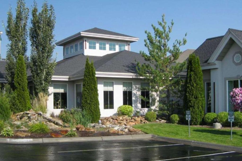 uma grande casa branca com paisagismo em Le Ritz Hotel and Suites em Idaho Falls