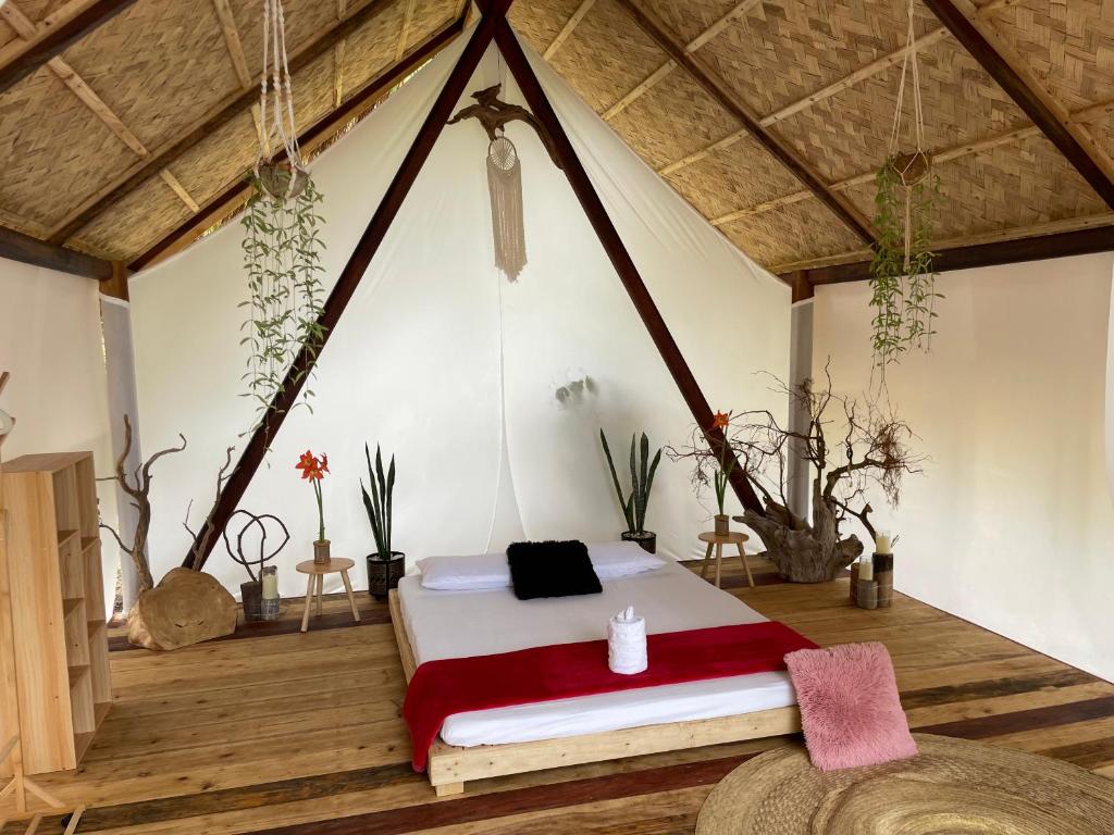 a bedroom with a bed in a room at Harmony Healing Project - Connect With Your Divinity in El Nido