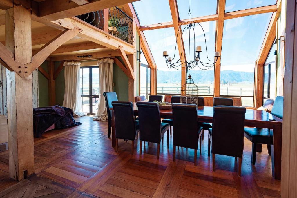 a dining room with a long table and chairs at housewithnonails in Matamata