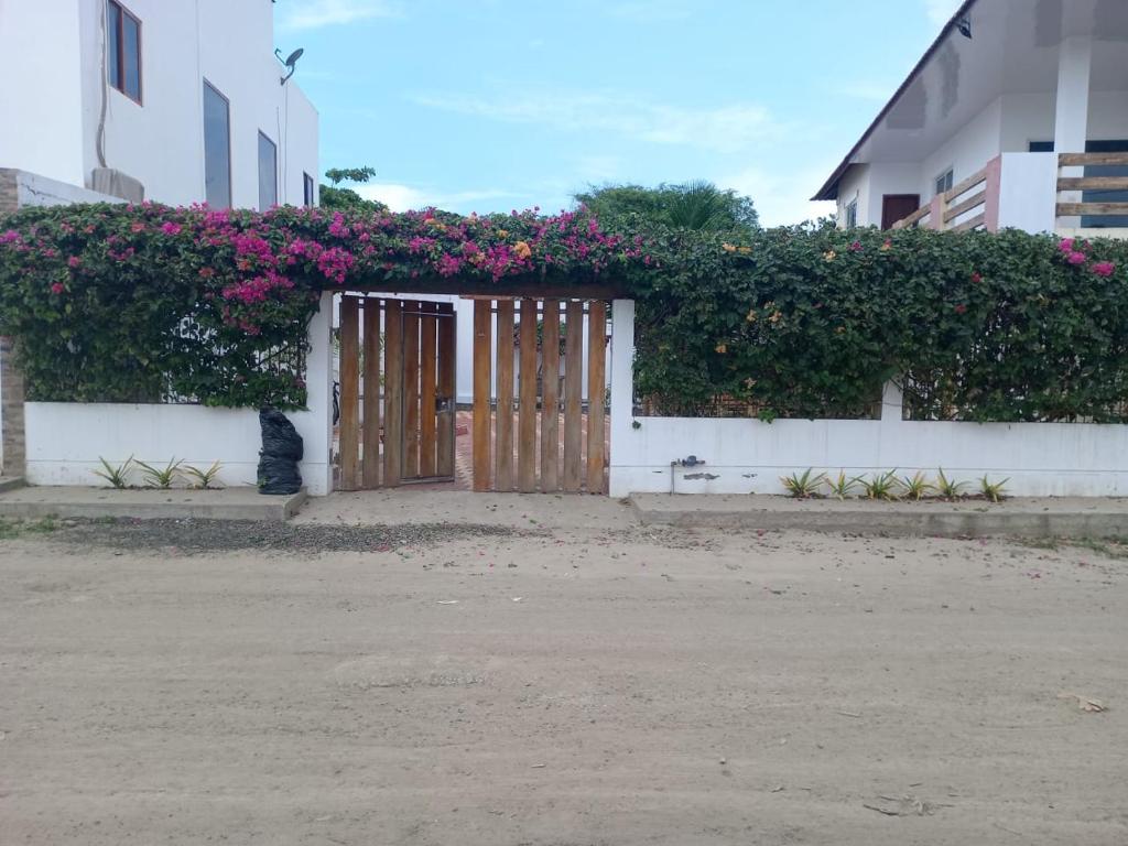 a wooden door with flowers on a building at Casa Veranera Beach in Hacienda San Clemente