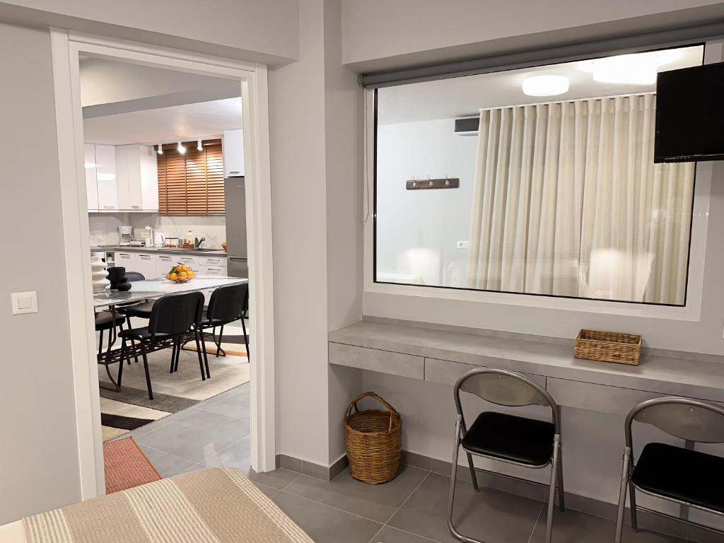 a kitchen and dining room with a large mirror at Eleni's Deluxe Apartment in Nafplio