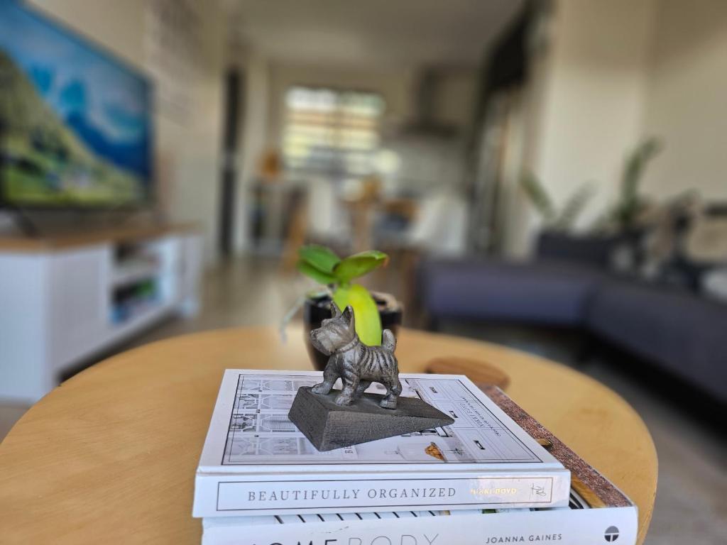 a toy cat sitting on top of two books on a table at Gazeley Gem in Hamilton