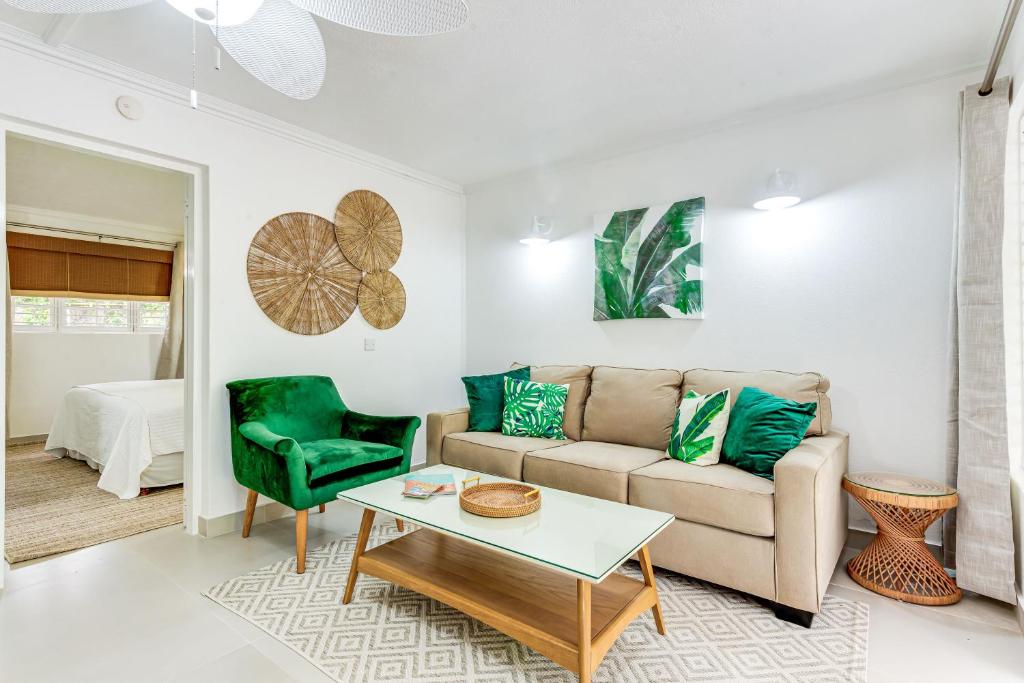 a living room with a couch and a table at The Palms Resort in Saint James