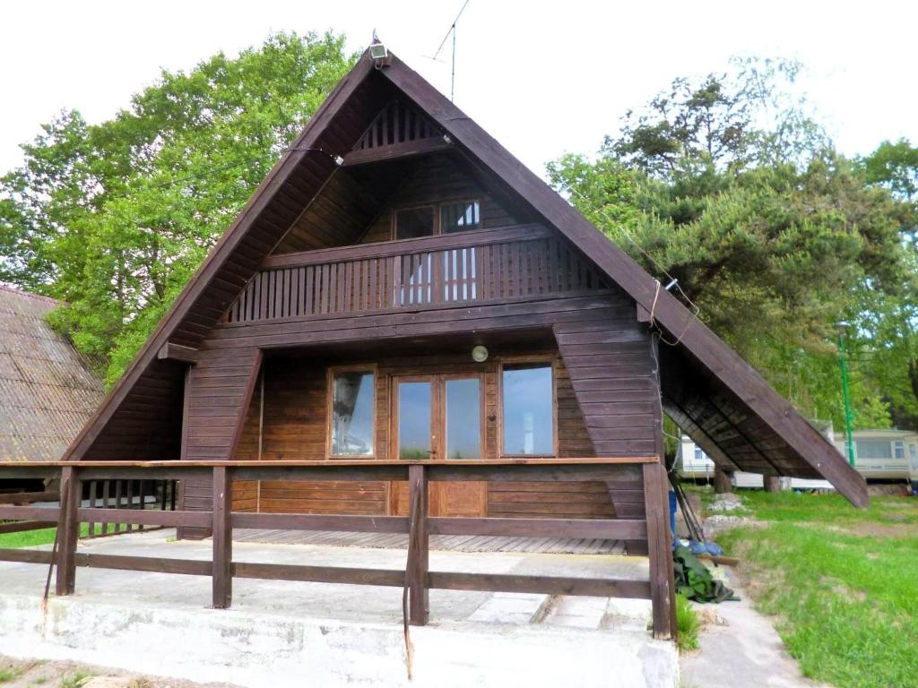 a small house with a thatched roof at House with a view of the lake, for 6 people in Łazy