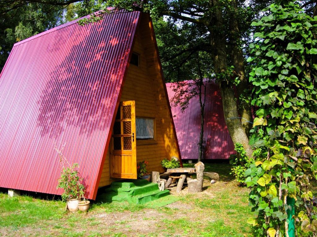 a small wooden house with a red roof at Summer house for 4 people, close to the sea in Łazy