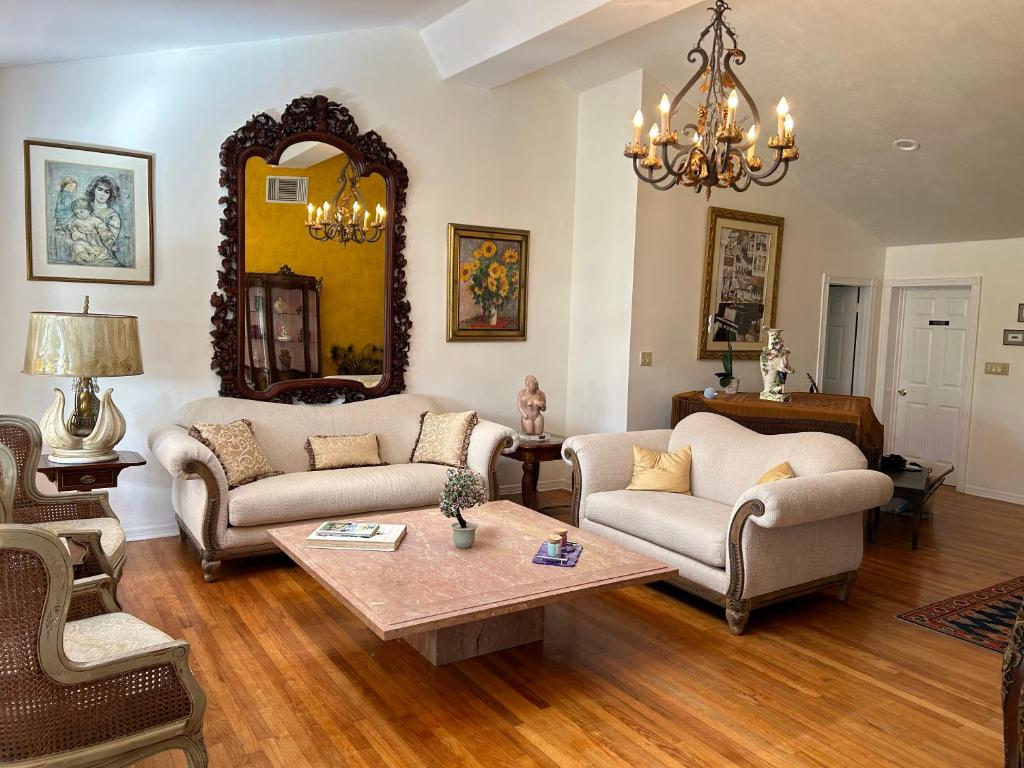 a living room with two couches and a table at Cozy House 3 large bedrooms 3full bath and king beds in West Palm Beach