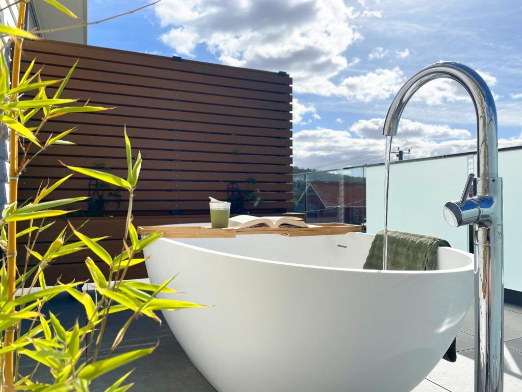 a bath tub sitting on top of a balcony at Little Island Apartments in Hobart