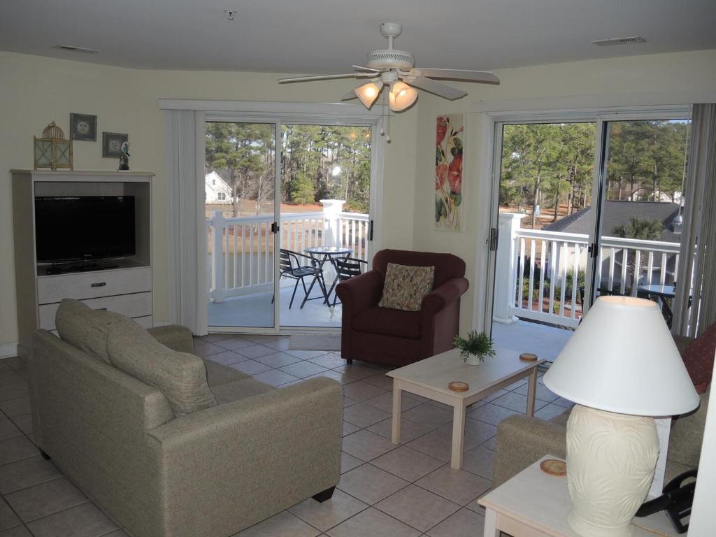 a living room with a couch and a television at Golf Resort Villa 2607 with Outdoor Pool in Calabash