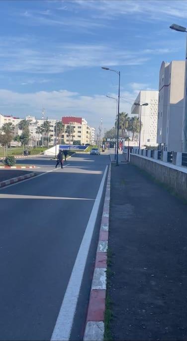 a person riding a skateboard down a city street at Appartement à RABAT AGDAL in Rabat
