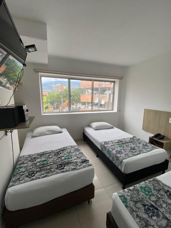 Postel nebo postele na pokoji v ubytování Suites Laureles