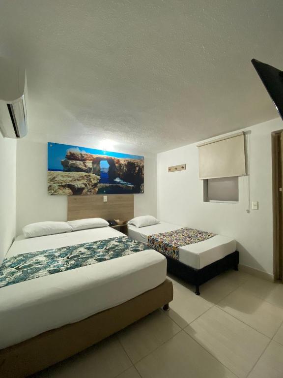 Postel nebo postele na pokoji v ubytování Suites Laureles