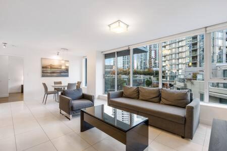 a living room with a couch and a table at Heart of Downtown Luxury 2BR Condominium in Vancouver