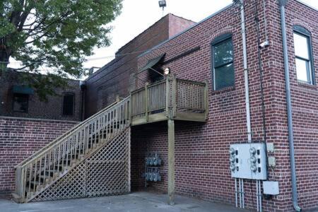 a brick building with a staircase on the side of it at Date Night - Ooo La La in Knoxville