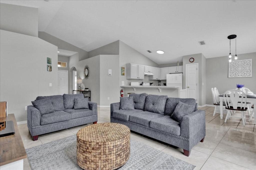 a living room with two couches and a table at 3 Bedrooms - 2 Bathrooms - Cumbrian Lakes 4695 Cl in Orlando