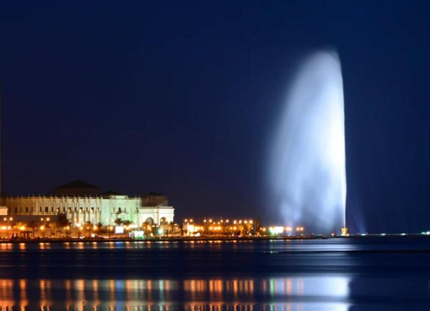 a large fountain in the water in front of a building at غرفه وحمام مشترك داخل شقه مشتركه للرجال فقط Single room and shared bathroom 2 Jeddah Corniche in Jeddah