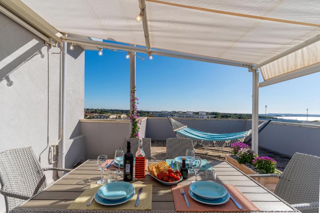 a table on a balcony with a view of the ocean at Terrazza vista mare e box auto in Gallipoli